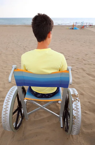 여름에 해변에서 특별한 휠체어를 타고 있는 어린 소년 — 스톡 사진