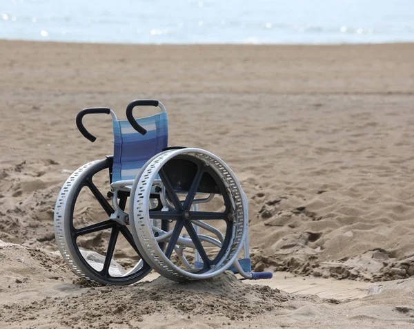 Rollstuhl mit großen Metallrädern am Strand — Stockfoto