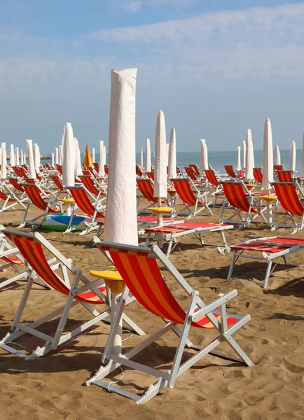 Beach on summer without people and closed parasoil — Stock Photo, Image