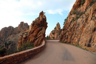 Narrow road called D81 in Corsica France and the rocks called Ca clipart