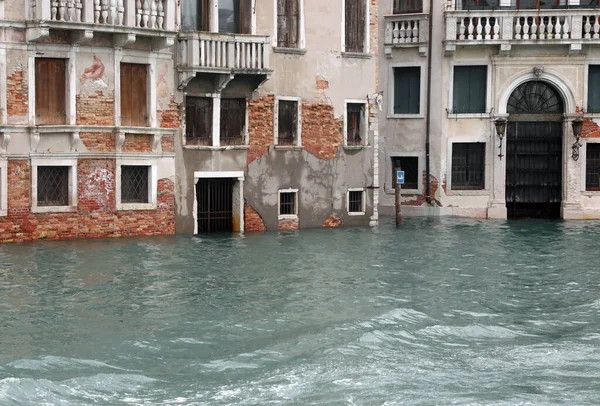 Houses with flooded entrances to Venice in Italy during high tide with