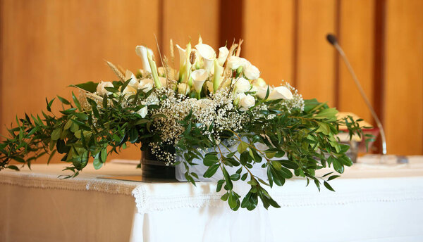 pot of flowers in the altair in the church without people