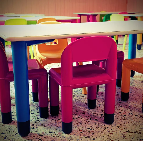 chairs and small tables in the classroom in the school without the children