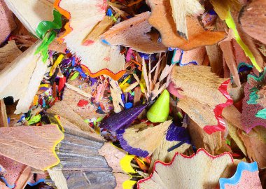 background of colorful pencil shavings after making the tip with the sharpener