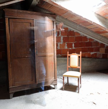 ghostly human presence that comes out of the closet in a dusty attic of the abandoned house