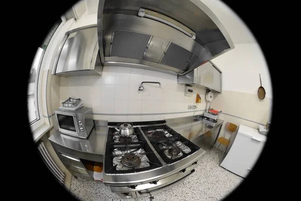 interior of the kitchen of a restaurant with the stove seen by a security camera installed to monitor the activities of the staff in secret