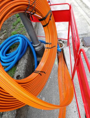 orange pipe for laying the optical fibers to connect companies and families on the internet clipart