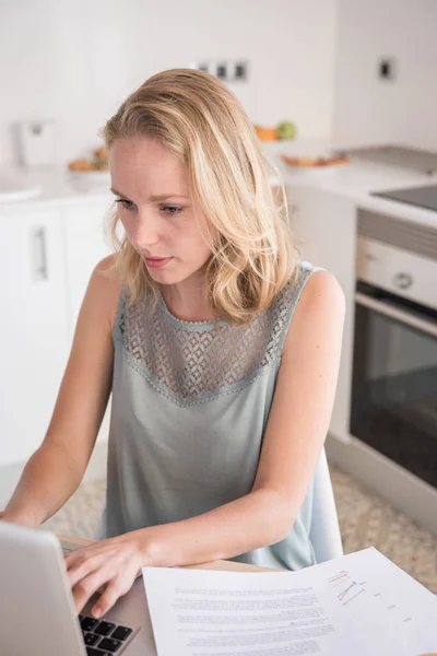 Mulher Digitando Laptop Enquanto Ela Senta Uma Mesa Uma Cozinha — Fotografia de Stock