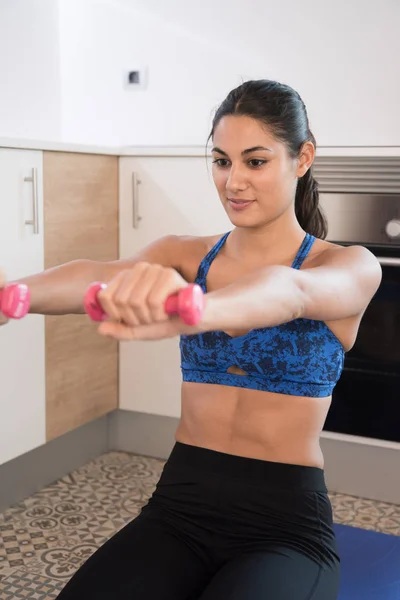 Woman Holds Weights Her Hands Her Arms Front Her She — Stock Photo, Image