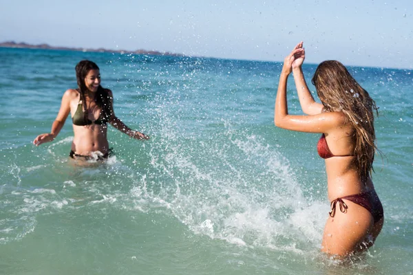 Due Ragazze Piedi Tra Onde Dell Oceano Spruzzarsi Vicenda Con — Foto Stock