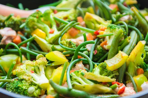fresh roasted vegetables. pepper, garlic broccoli, arrows and lots of peas. a beautiful mix of vegetables. healthy eating