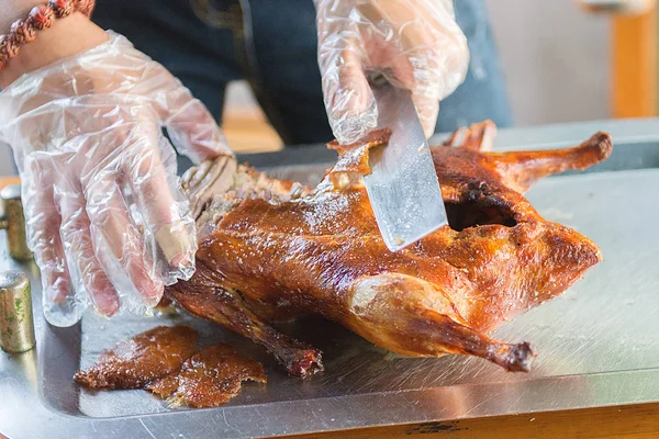 Cook cut up a juicy duck Peking, beautiful, bright and tasty dish that is ready to supply the cook.