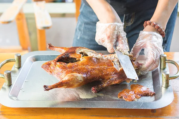 Cook cut up a juicy duck Peking, beautiful, bright and tasty dish that is ready to supply the cook.