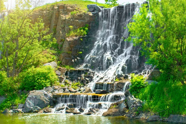 Bela cachoeira sob a luz do sol, muitos jatos de água bonita cercada por florestas verdes . — Fotografia de Stock