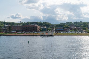Geniş açık bir günde atış kurmak güzel nehir sahil kasabası. Ufuk doğru nehir tekne geçen su görüntülemek.
