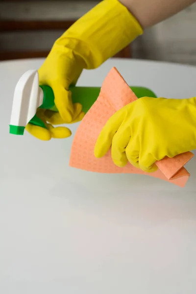 Mãos de mulher com equipamento de limpeza no fundo branco — Fotografia de Stock