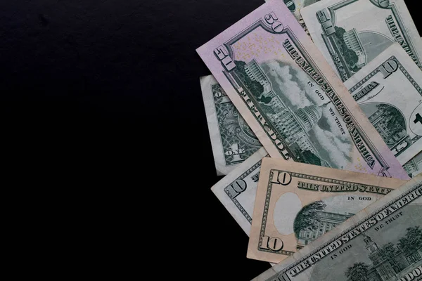 stock image hundred dollars banknotes on black background.