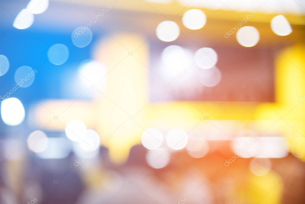 Abstract blurred of festival event with people and motor show background. Convention and Business event concept. People and lifestyle theme. Orange and Blue light tone. Defocused photo