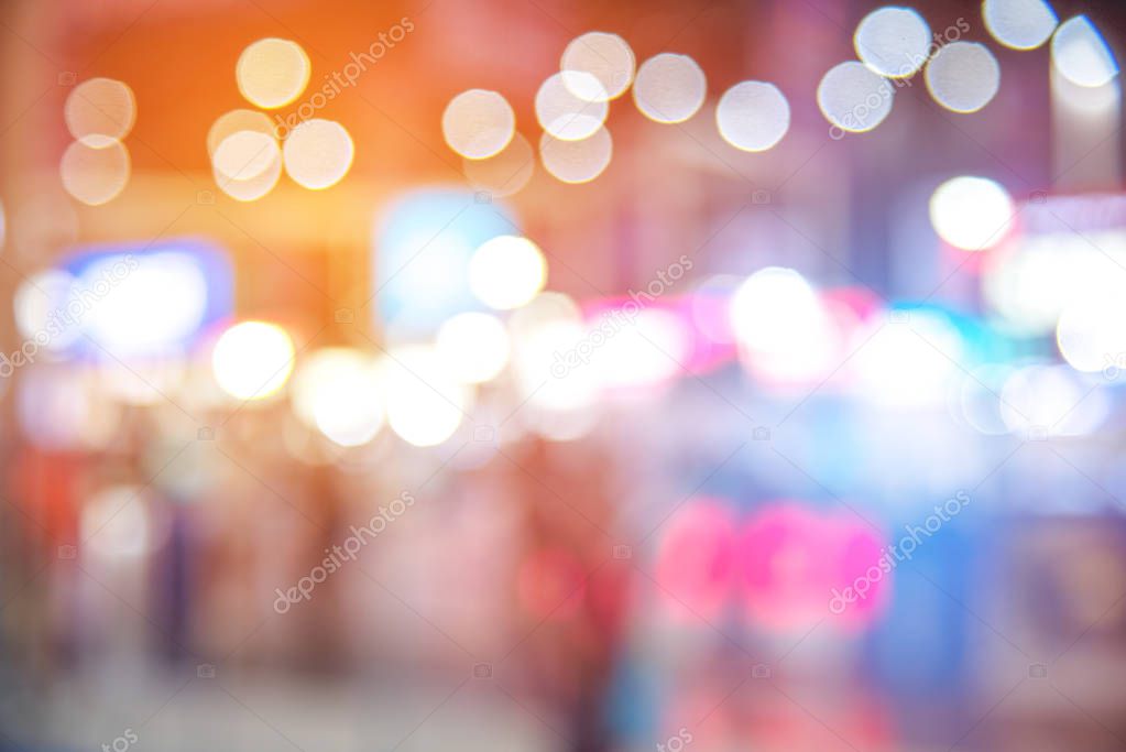 Abstract blurred of festival event with people and motor show background. Convention and Business event concept. People and lifestyle theme. Orange and Blue light tone. Defocused photo