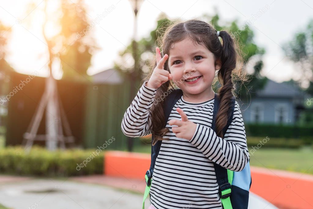 Happy little girl enjoy going to school. Back to school and Education concept. Happy life family lifestyle theme. Cheering up gesture