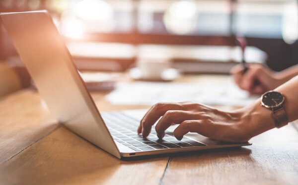 Close up of business woman typing laptop keyboard and making report in office. Business and Lifestyles concept. Entrepreneur and Freelance theme.