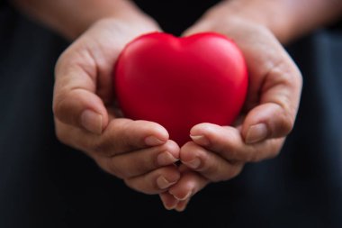 Close up hands giving red heart as heart donor. Valentine day of love concept. Medical ventilator and heart donator charity. Sign of compassion and healthy. Helping hand in freedom life donation