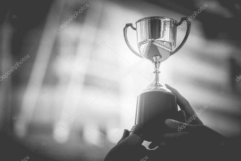 Black and white trophy with city background. Success and achievement concept. Sport game and award theme. Monochrome color theme.