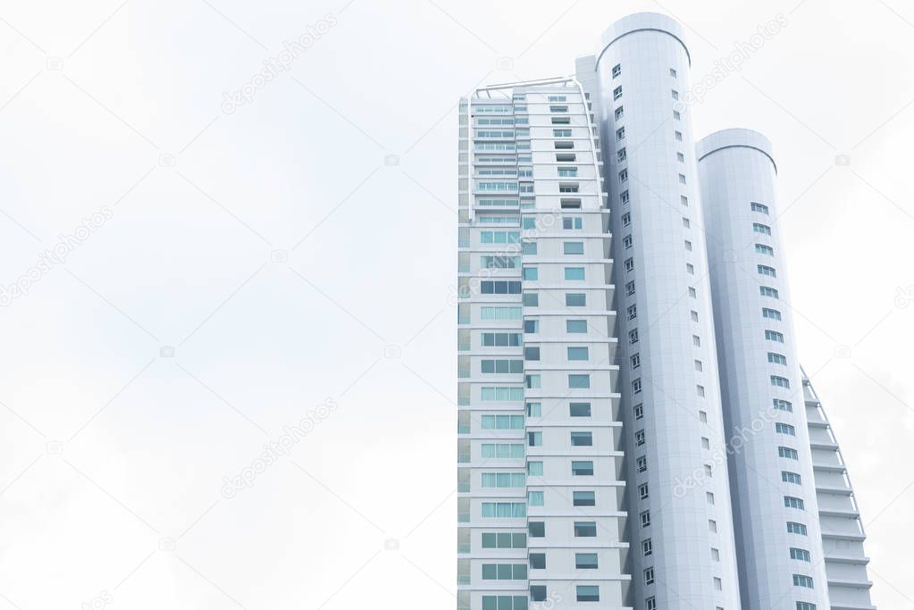 Tall building with clear white sky. Architecture and structure concept. People life and living theme.