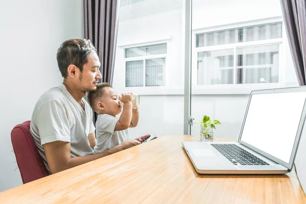 Asya Baba Oğul Kullanarak Akıllı Telefon Dizüstü Arka Planda Birlikte — Stok fotoğraf
