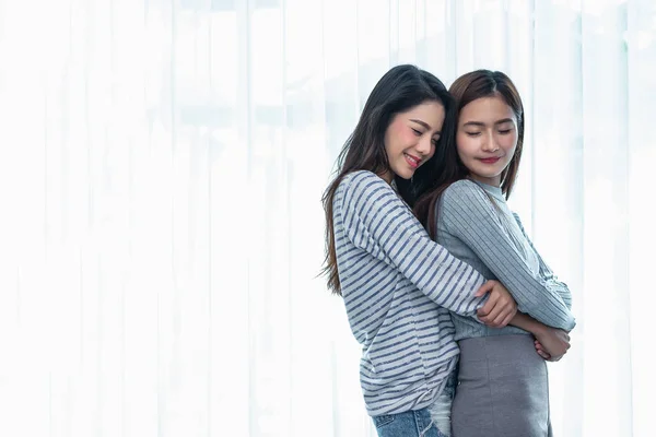 Two Asian Lesbian women hug and embracing together in bedroom. Couple people and Beauty concept. Happy lifestyles and home sweet home theme. Homosexual life theme. Love scene making of female