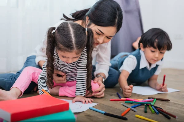 Mãe ensinando crianças na aula de desenho. Filha e filho dor — Fotografia de Stock