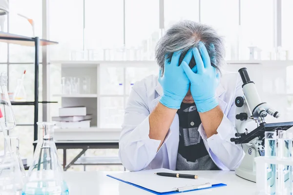 Exhausted scientist sleeping in laboratory. People lifestyles an — Stock Photo, Image