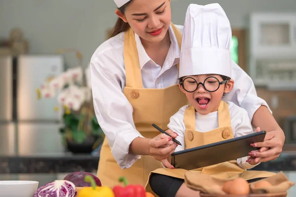 Hermosa mujer asiática y lindo niño pequeño preparar en línea shoppin — Foto de Stock