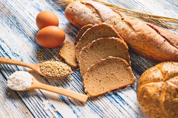 Diferentes tipos de pan con nutrición granos enteros en madera — Foto de Stock