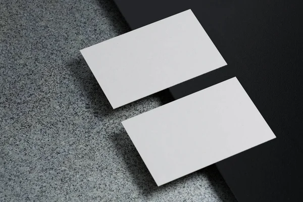 White horizontal business card paper mockup template with blank space cover for insert company logo or personal identity on black cardboard floor background. Modern concept. 3D illustration render