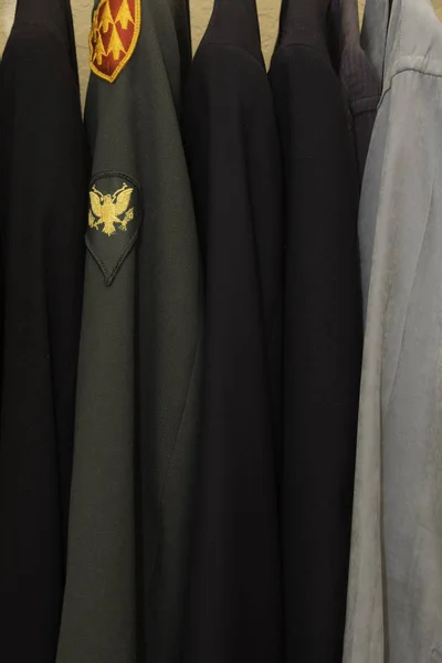 Military clothing in a closet with shirts and jackets