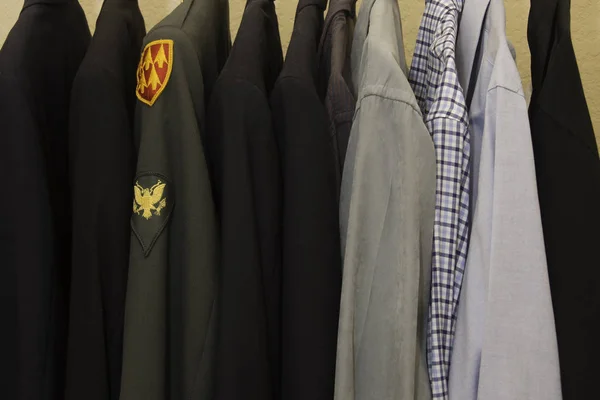 Military clothing in a closet with shirts and jackets
