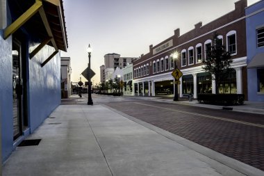 Morning at Kissimme Florida showing downtown traffic and older buildings clipart