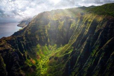 Landscape view of Na Pali coastline cliffs with sunlight glow, Kauai, Hawaii, USA clipart