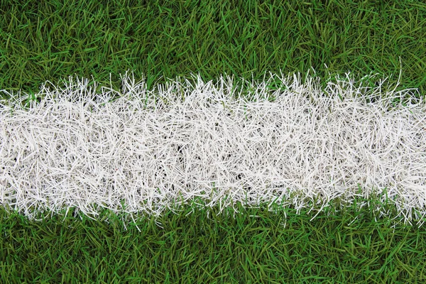 Artificial grass on the football field. Top view. Close-up. Background. Texture.