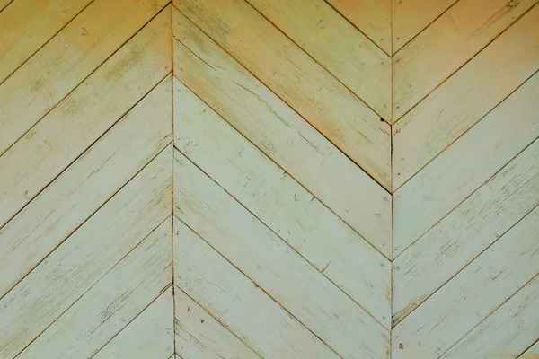 The wall of the house is made of thin boards in the form of a pattern. Close-up. Background. Texture.