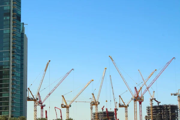 United Arab Emirates. Hoisting tower cranes. Construction of skyscrapers.
