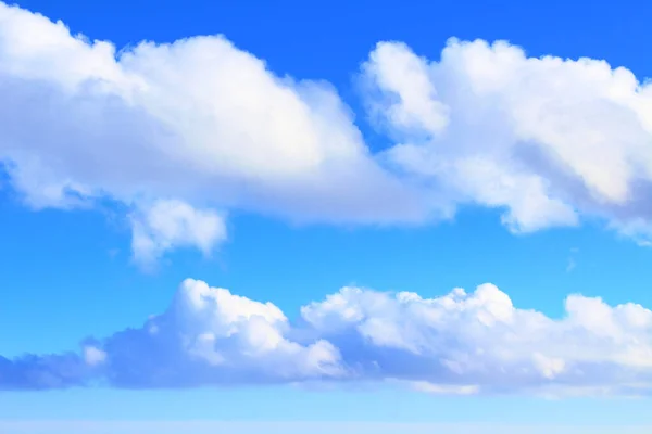 Blue sky and cumulus clouds. Horizontal view. Close-up. Background. Landscape.