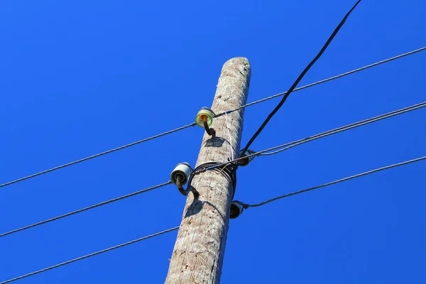Wooden pole with electrical wires. Power line. Close-up. Background. Texture.