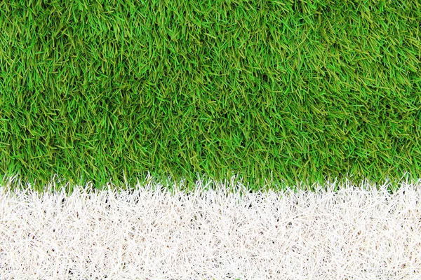 Artificial green grass on the football field. Top view. Close-up. Background. Texture.