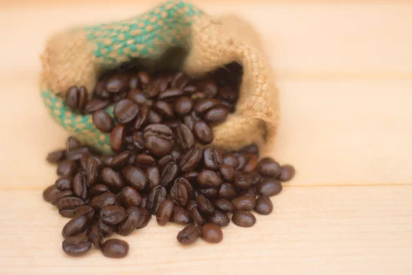 coffee beans in the vintage bag on the brown background