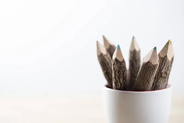white coffee cup and wood pencil on the white background