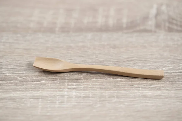 little wood spoon on the wood brown table