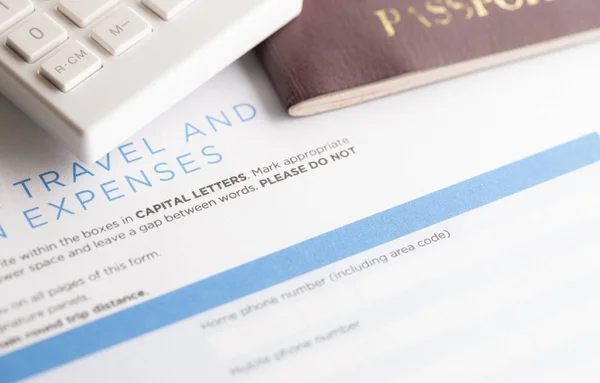 travel form with calculator and passport on the table