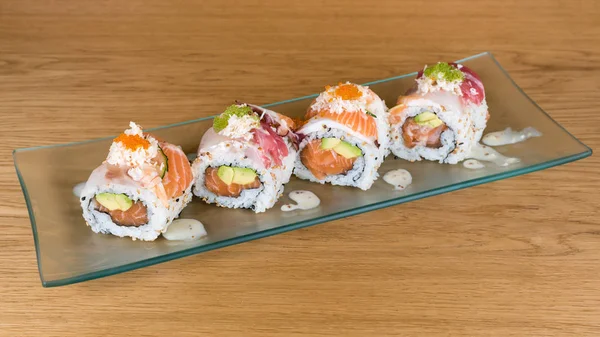 Special Uramaki, rice roll stuffed with salmon avocado, covered